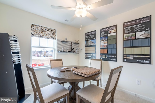 carpeted dining area featuring ceiling fan