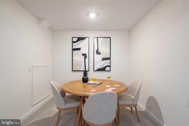 dining space featuring light colored carpet