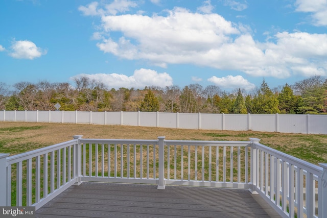 wooden terrace featuring a yard