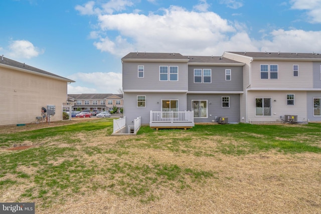 back of property with central AC unit, a yard, and a wooden deck