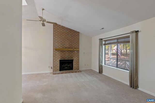 unfurnished living room featuring ceiling fan, light carpet, vaulted ceiling, and a fireplace