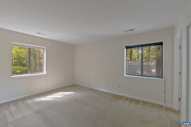 carpeted empty room with plenty of natural light