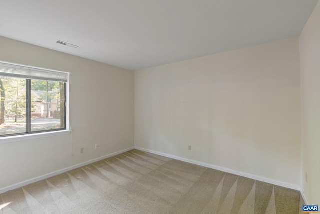 spare room with light colored carpet