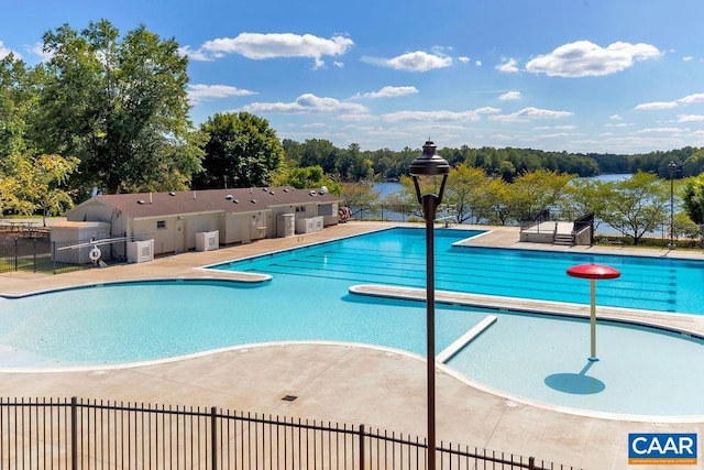 view of pool featuring a water view and a patio area