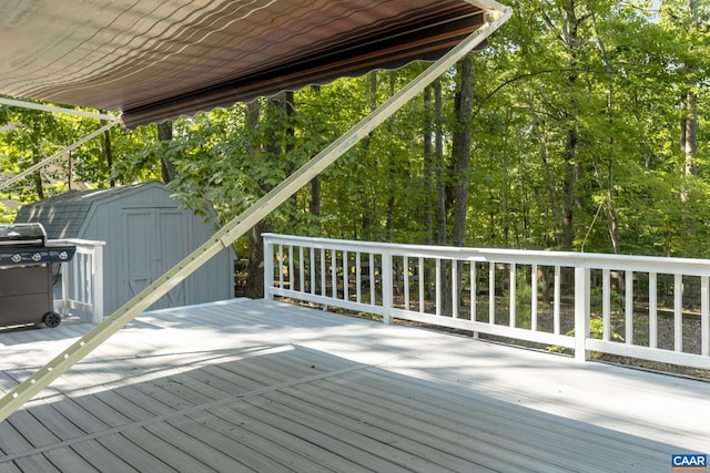 deck featuring a grill and a storage unit