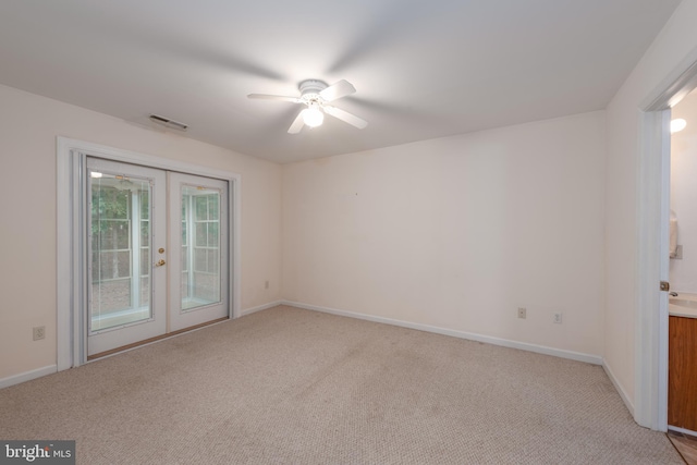 unfurnished room with light colored carpet, ceiling fan, and french doors