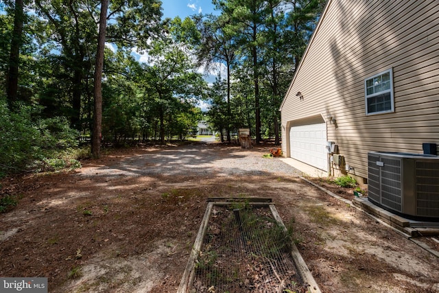 view of yard with cooling unit and a garage