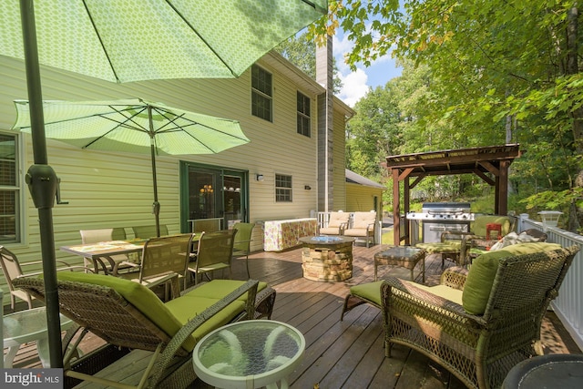 deck with grilling area and an outdoor living space with a fire pit