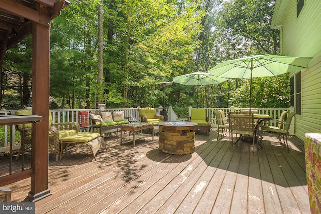 wooden terrace with a fire pit