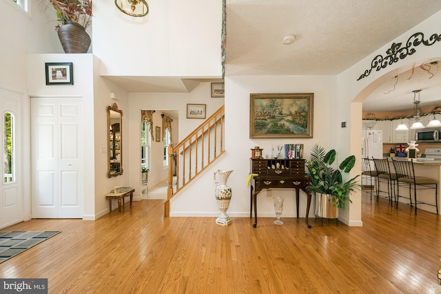 entrance foyer featuring a textured ceiling and light wood-type flooring