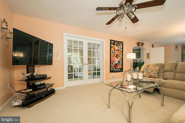 carpeted living room featuring a textured ceiling and ceiling fan