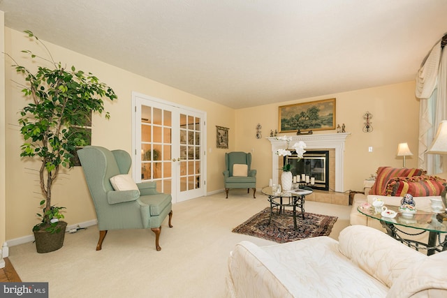 carpeted living room featuring a tiled fireplace