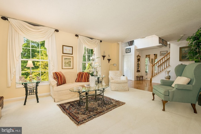 carpeted living room featuring a textured ceiling