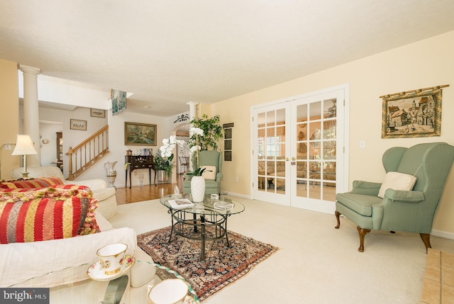 living room with light carpet and ornate columns