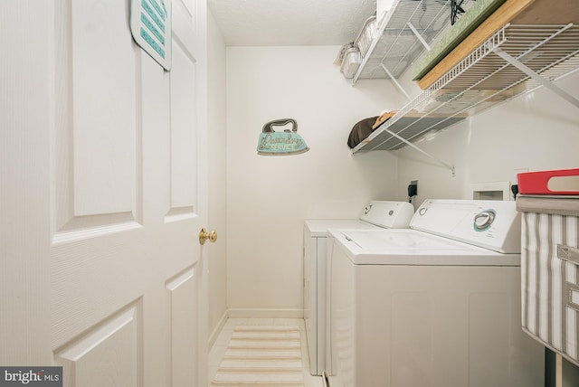 clothes washing area featuring washer and dryer