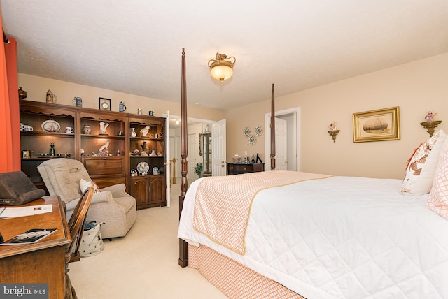 carpeted bedroom featuring a textured ceiling