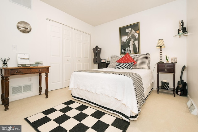 bedroom with a closet and light carpet