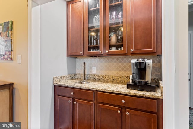 bar featuring backsplash and a sink