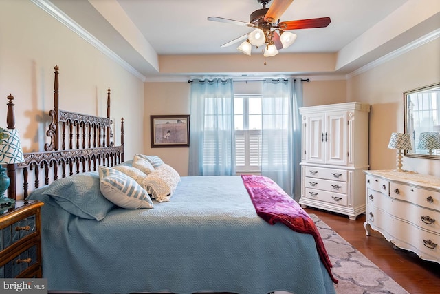 bedroom with dark wood-style floors, multiple windows, and crown molding