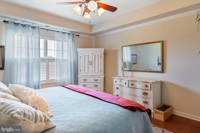 bedroom with baseboards, wood finished floors, a ceiling fan, and crown molding