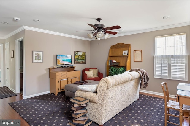 living area with ornamental molding, a ceiling fan, baseboards, and dark wood-style floors