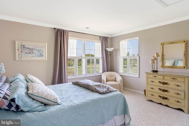 bedroom with light carpet, crown molding, and baseboards