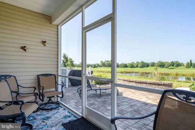 sunroom / solarium with a water view