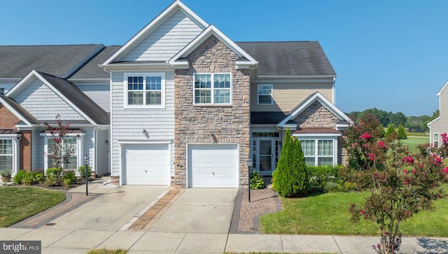 craftsman house featuring a front yard, stone siding, driveway, and an attached garage