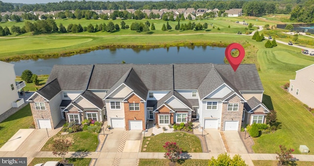 birds eye view of property with view of golf course and a water view