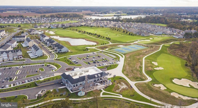 aerial view with golf course view, a water view, and a residential view