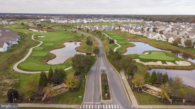 aerial view featuring view of golf course, a water view, and a residential view