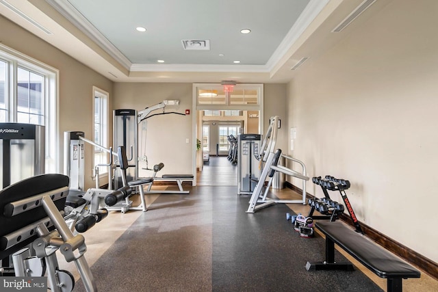 workout area featuring recessed lighting, a raised ceiling, visible vents, ornamental molding, and baseboards