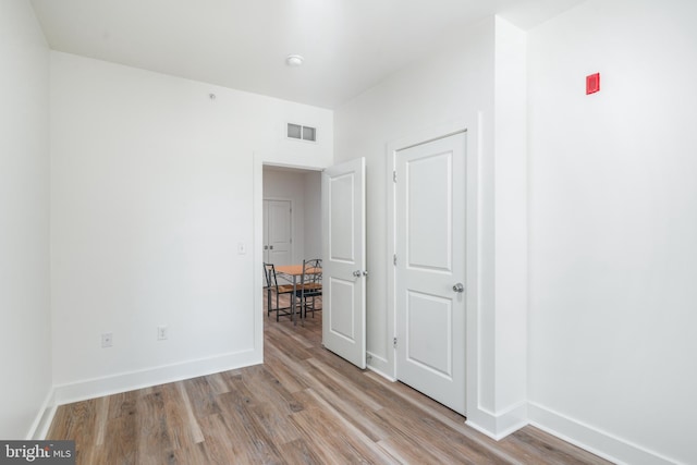 spare room featuring light hardwood / wood-style flooring