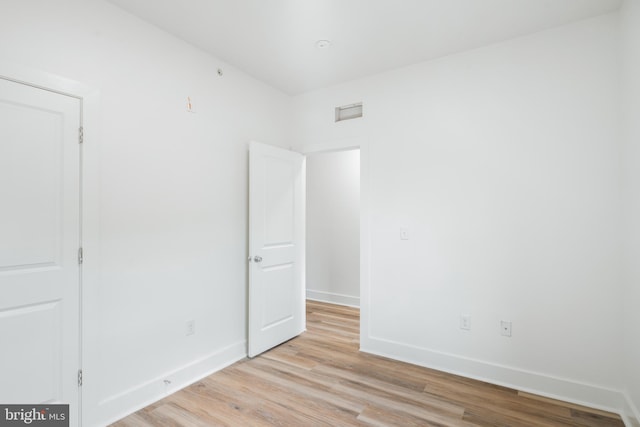 spare room featuring light hardwood / wood-style floors