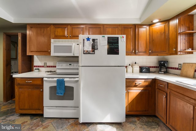 kitchen with white appliances and tasteful backsplash