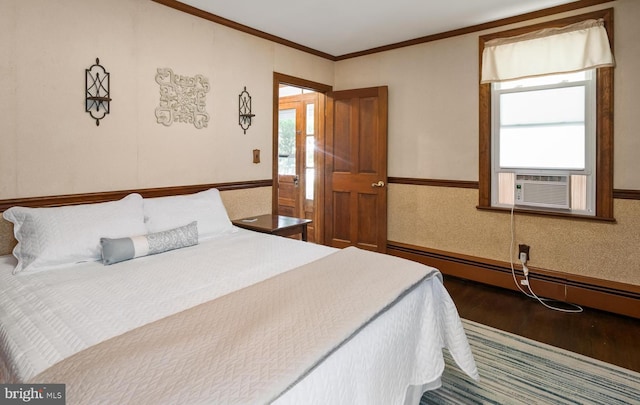 bedroom featuring cooling unit, a baseboard radiator, dark hardwood / wood-style floors, and ornamental molding