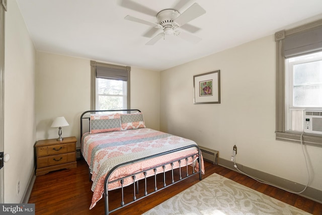 bedroom with baseboard heating, ceiling fan, and dark hardwood / wood-style floors