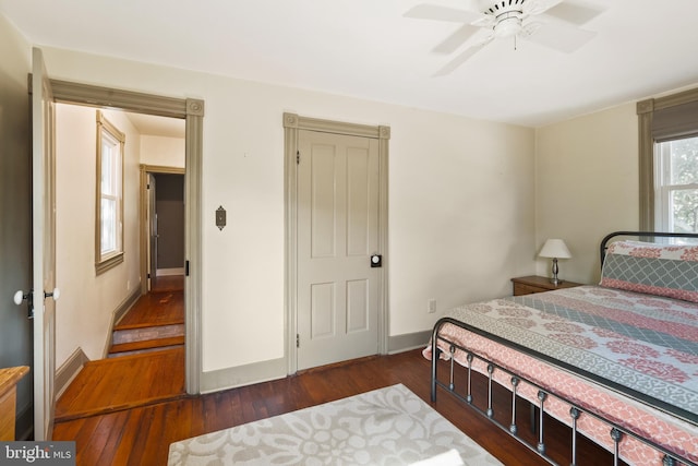 bedroom with dark wood-type flooring and ceiling fan