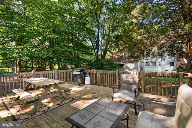 wooden deck with outdoor dining space and a grill