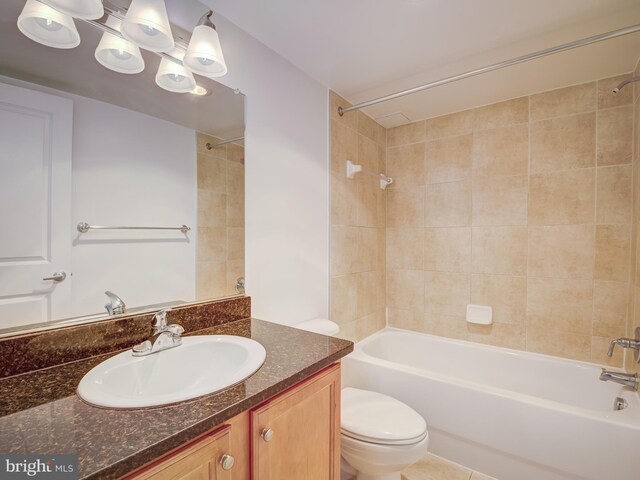 full bathroom with tile patterned flooring, vanity, toilet, and tiled shower / bath combo