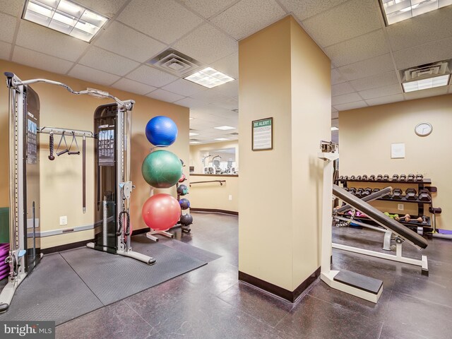 exercise room featuring a paneled ceiling