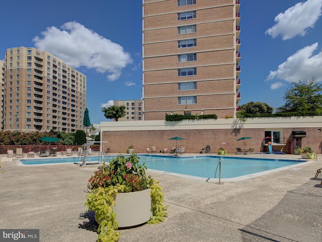 pool featuring a patio area and fence