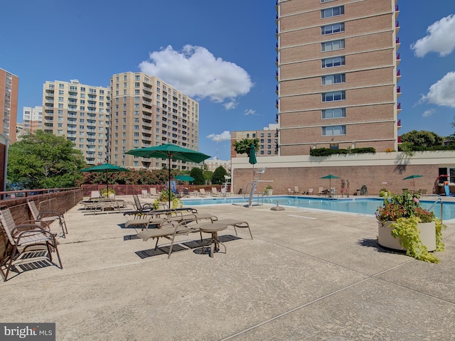 pool featuring fence and a patio