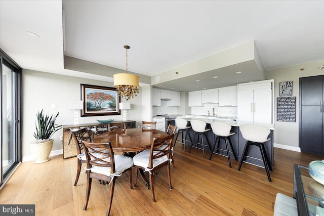 dining area with light hardwood / wood-style flooring and a wealth of natural light