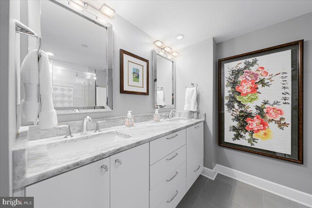 bathroom featuring tile patterned floors, vanity, and a shower with door