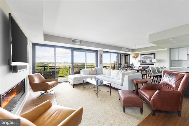 living room featuring a wealth of natural light and light hardwood / wood-style flooring