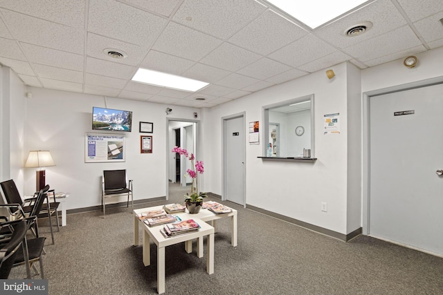 playroom featuring carpet flooring and a drop ceiling