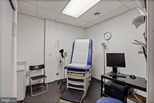 office area featuring a drop ceiling, visible vents, and baseboards