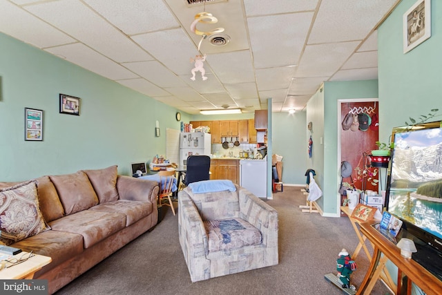 carpeted living room featuring a paneled ceiling