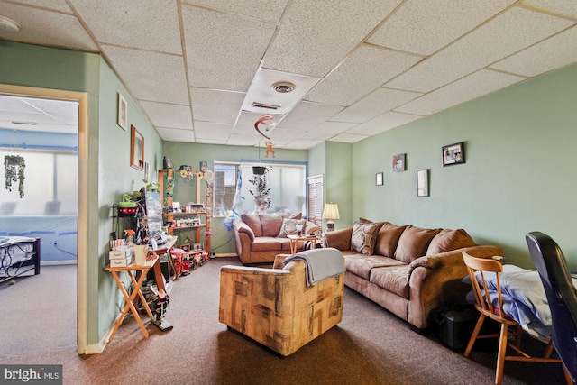 carpeted living room with a drop ceiling